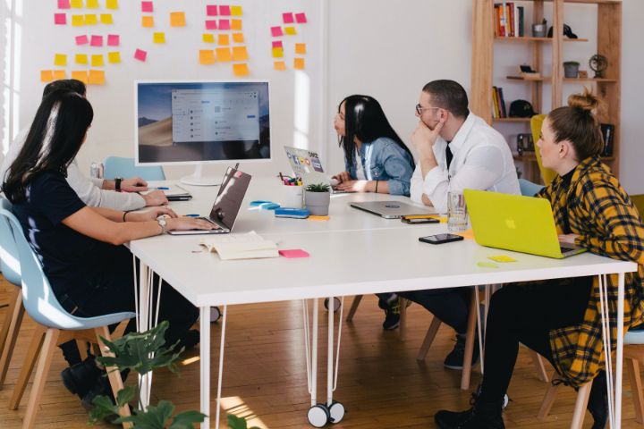 People at table working with technology