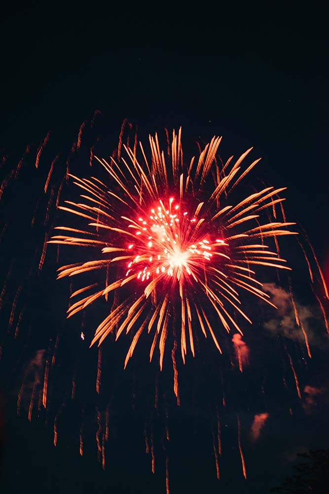 red and orange fireworks at night