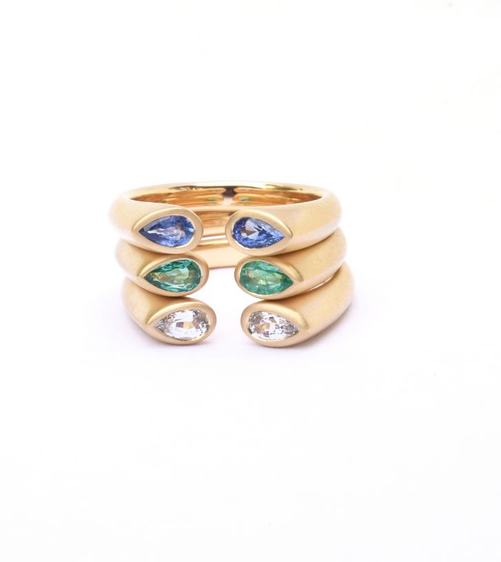 Kimberly Collins Colored Gems 18K Yellow hug rings in blue sapphire, emerald, & white sapphire MSRP $2490 kimberlycollinsgems.com 775.622.0600